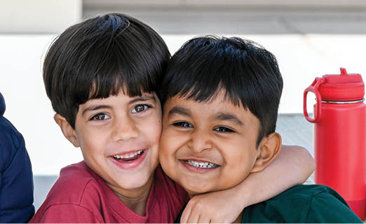 Three children are hugging each other, smiling and laughing. AI generated content