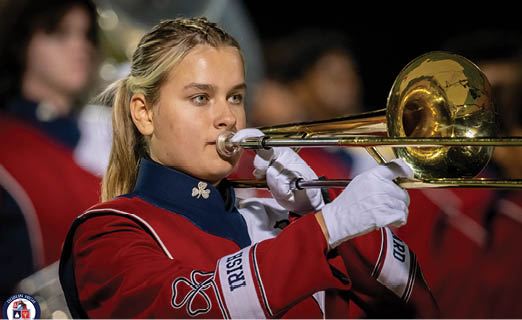 A woman in a red and white uniform plays a trombone. AI generated content