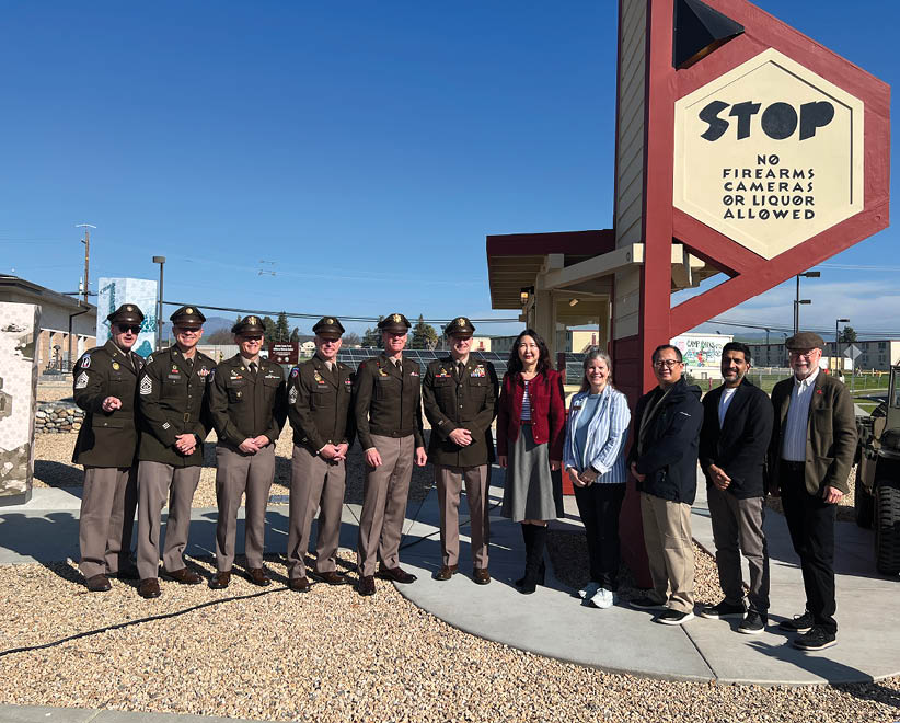 A group of men and women pose in front of a stop sign. AI generated content