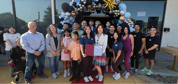 A group of people, including children, pose for a photo in front of a building. AI generated content