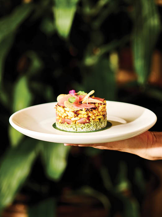 A person is holding a plate with a small cake on it. AI generated content