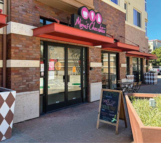 A storefront with a sign that says “Mom's Chalet" and a pink heart. AI generated content