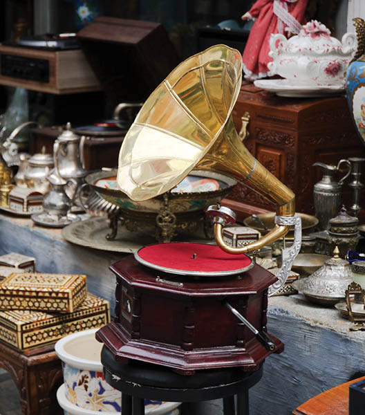 An old gramophone and other antique objects at antiques market in street