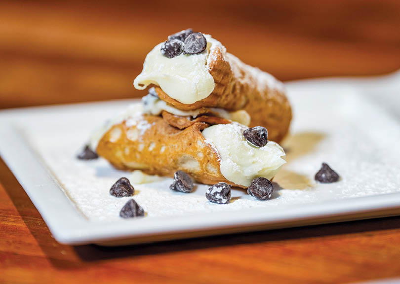A plate with a pastry and chocolate chips. Description generated by AI