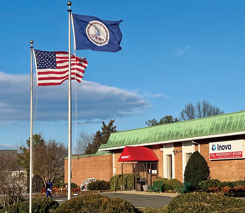 Two flags on poles in front of a building. Description generated by AI