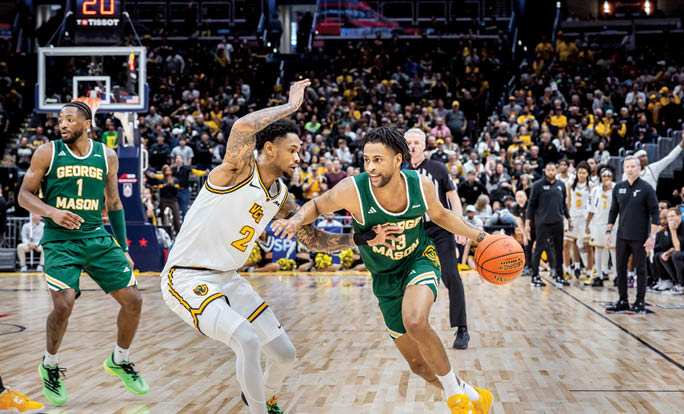 A basketball game with two teams playing. Description generated by AI