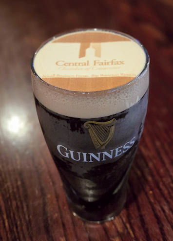 A glass of beer with a sticker on it. Description generated by AI