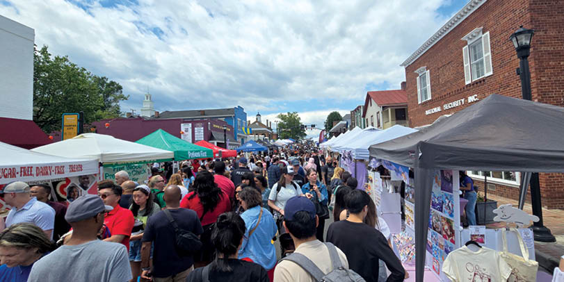 A large group of people are gathered in a street. Description generated by AI