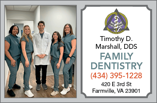 A group of five people, including a man and four women, pose for a photo in front of a dentist's office. AI generated content