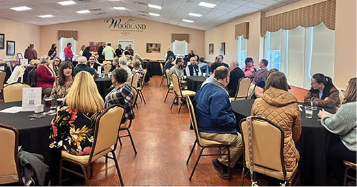 A group of people are sitting around a large dining table in a restaurant. AI generated content