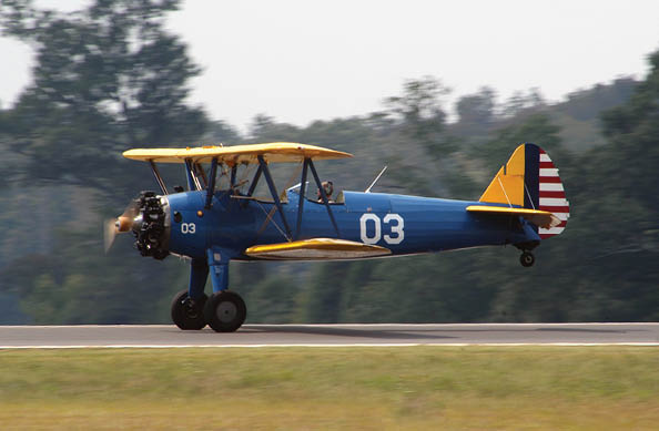 Antique Stearman PT-17 biplane touching down at the Faquier County, Virginia Airport.