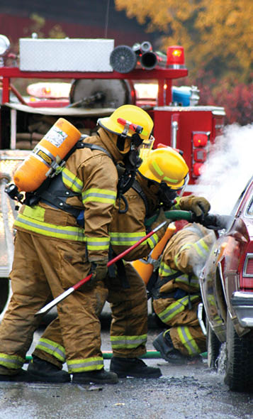 firemen with burning car