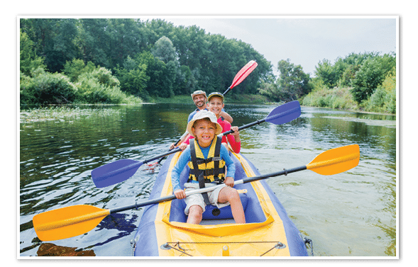 Active happy family. Boy with his sister and father having fun together enjoying adventurous experience kayaking on the river on a sunny day during summer vacation