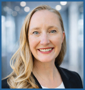 A woman wearing a black suit and white shirt. Description generated by AI