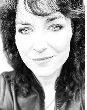 A woman with long hair and a leather jacket. Description generated by AI
