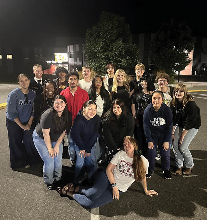 A group of people posing for a picture. Description generated by AI