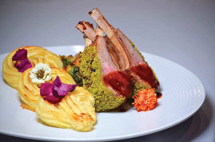 A white plate with a piece of meat and a sauce. Description generated by AI