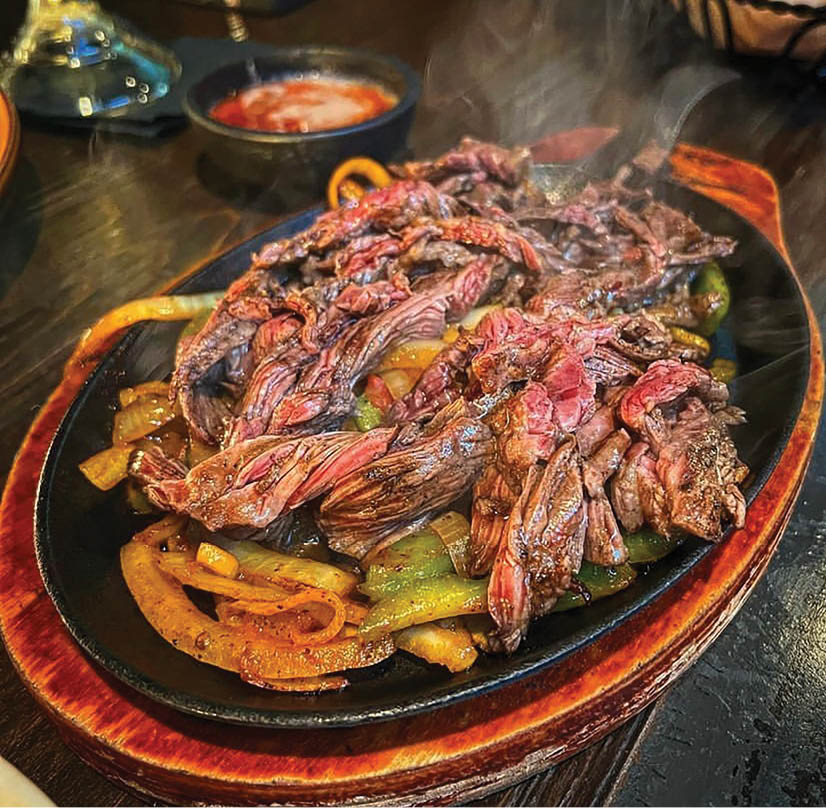 A plate of food with meat and vegetables. Description generated by AI