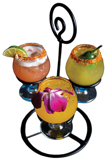 Three glasses of mixed drinks with fruit garnishes. Description generated by AI