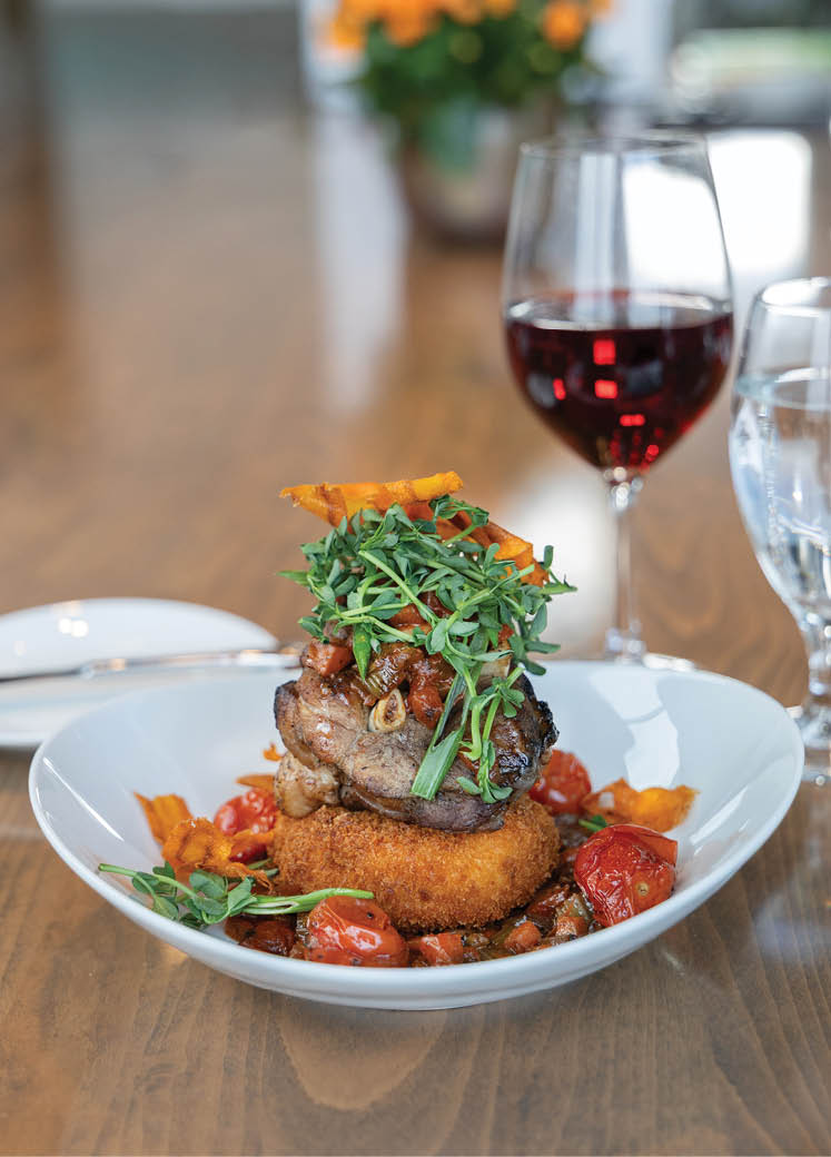 A plate of food with a glass of wine. Description generated by AI