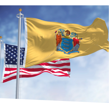 The New Jersey state flag waving along with the national flag of the United States of America. In the background there is a clear sky. New Jersey s a state in the Northeastern regions of the US