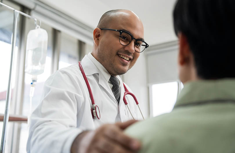 Doctors encourage patients recovery service. Doctors treat patients diseases. Life and health insurance. Advice to young man consulting about treatment