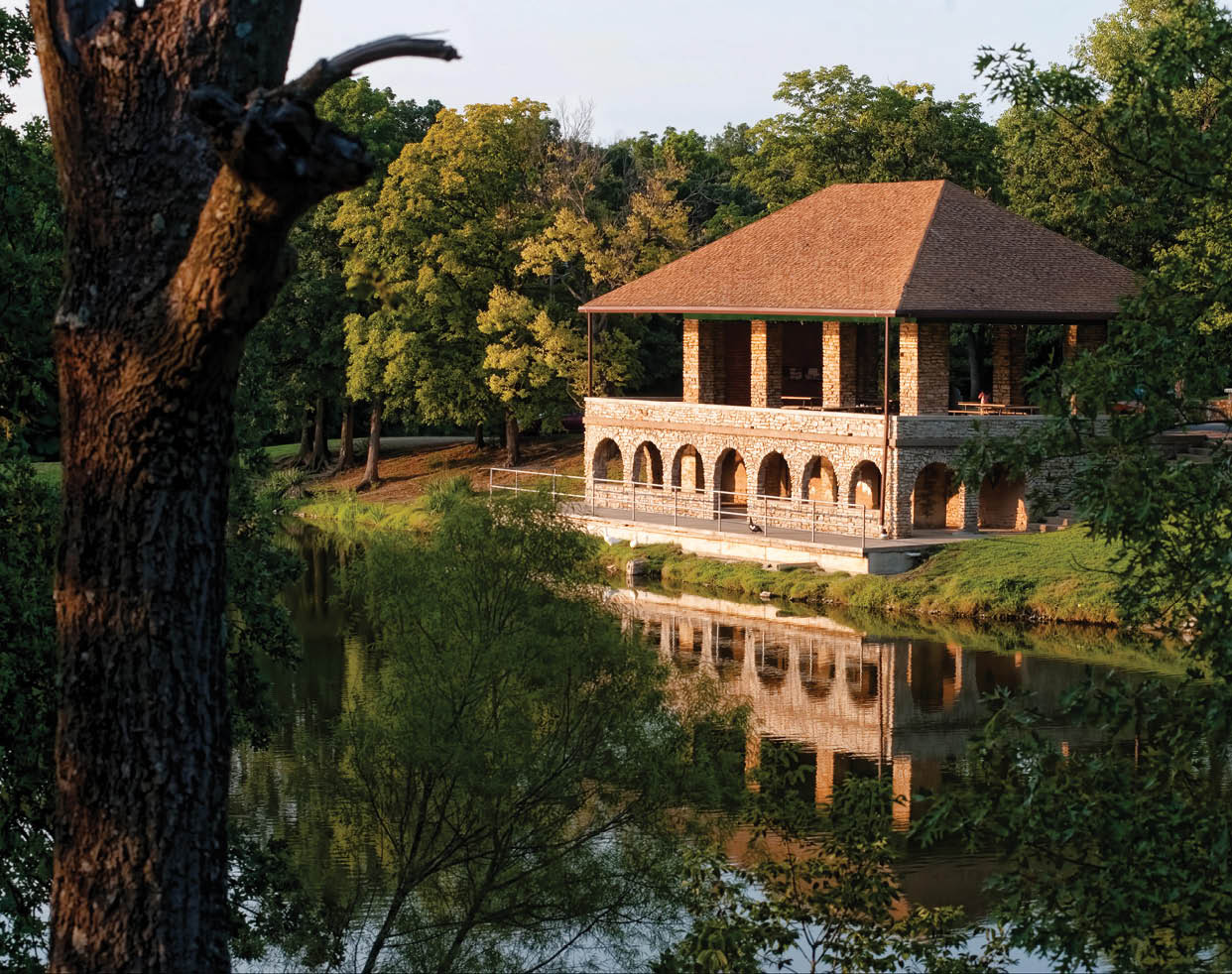 A large building with a red roof is reflected in a lake. AI generated content