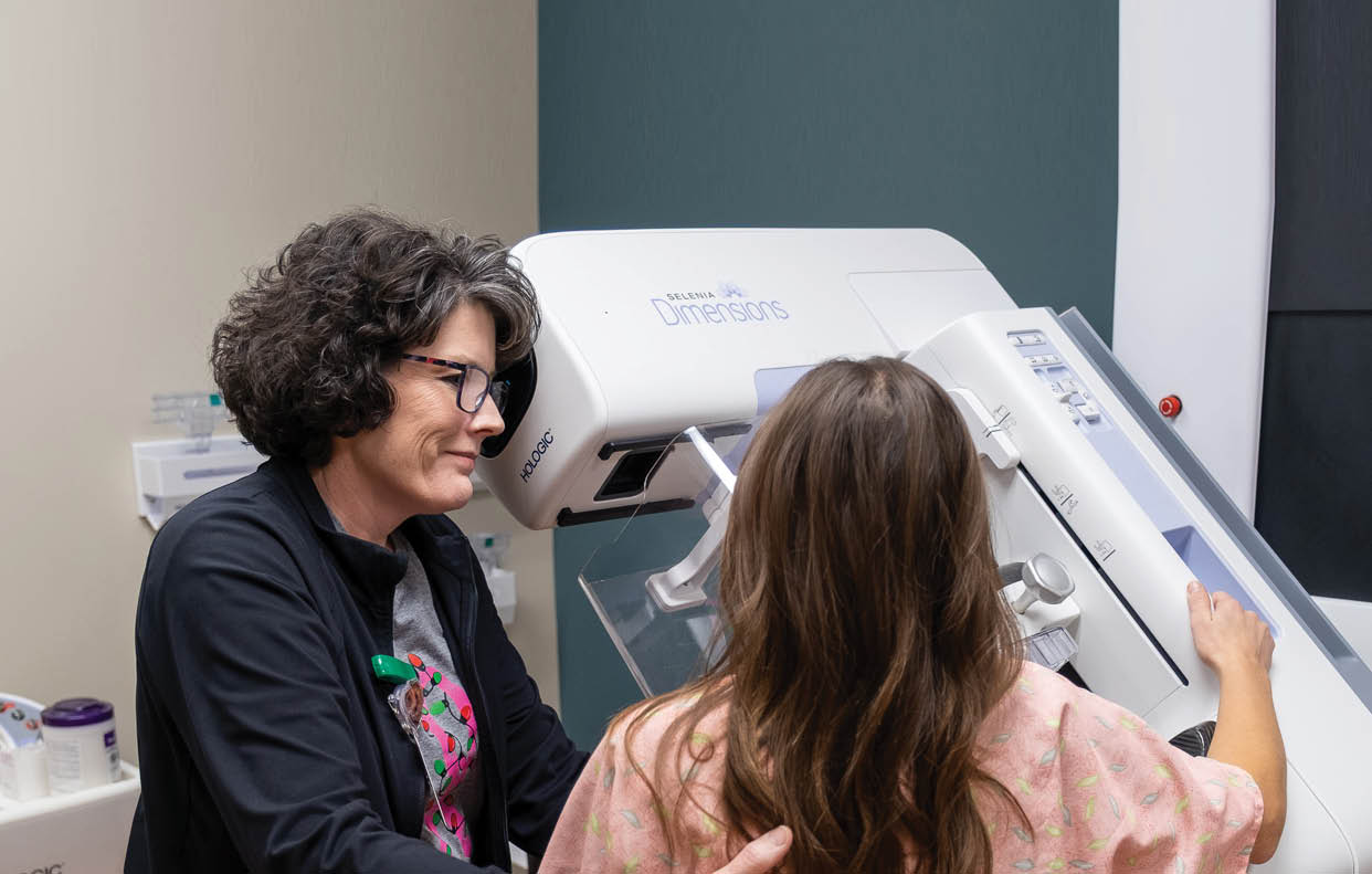 A woman is getting a mammogram from a technician. AI generated content