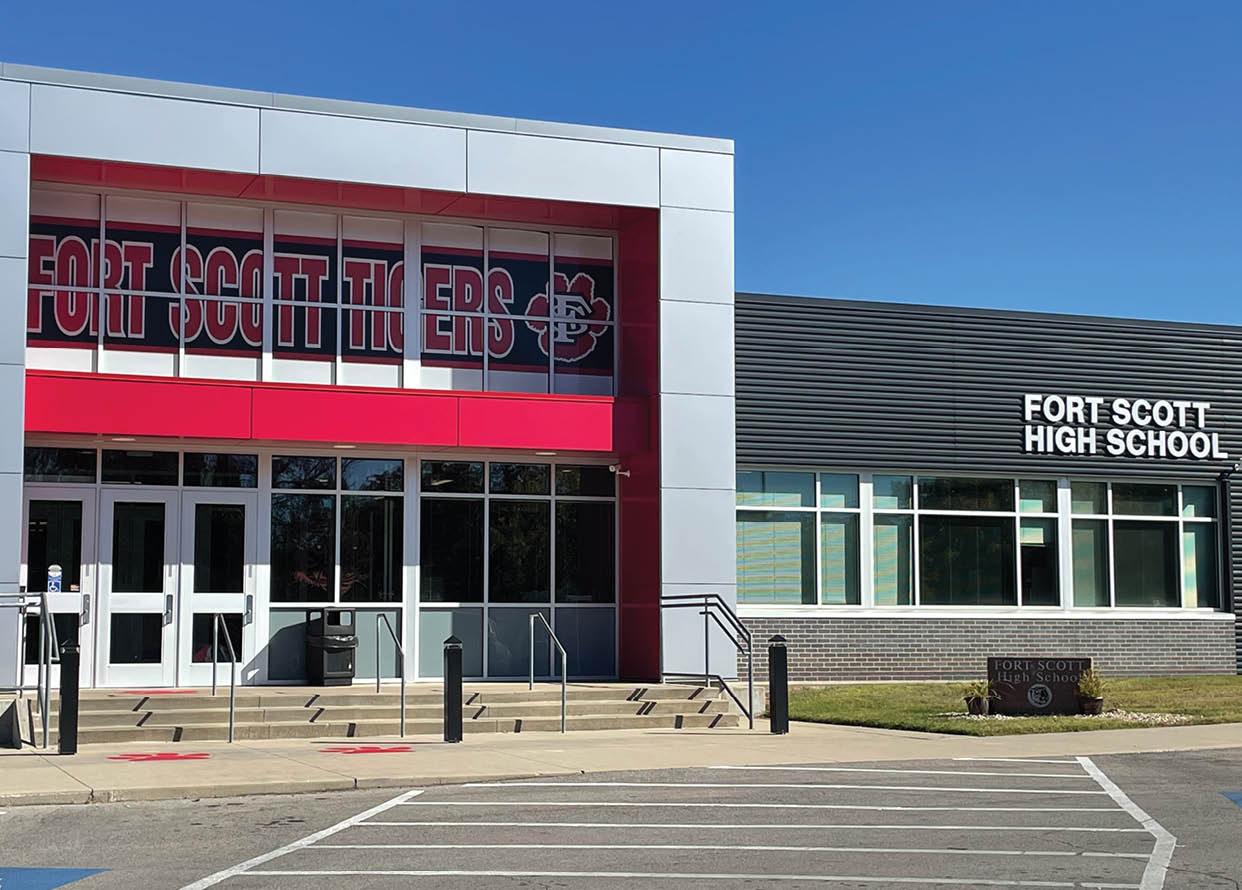 A high school building with a red and white sign. AI generated content