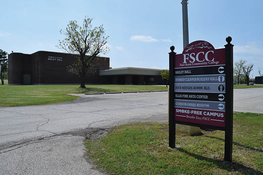 A sign is posted on the side of the road, indicating the location of a college. AI generated content
