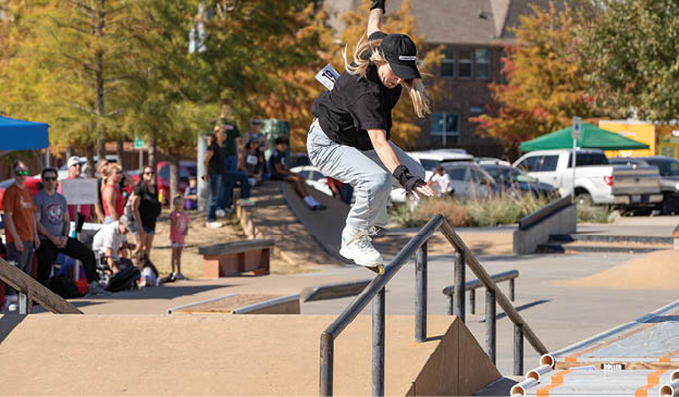 A young man is performing a trick on a skateboard, jumping over a metal rail. AI generated content