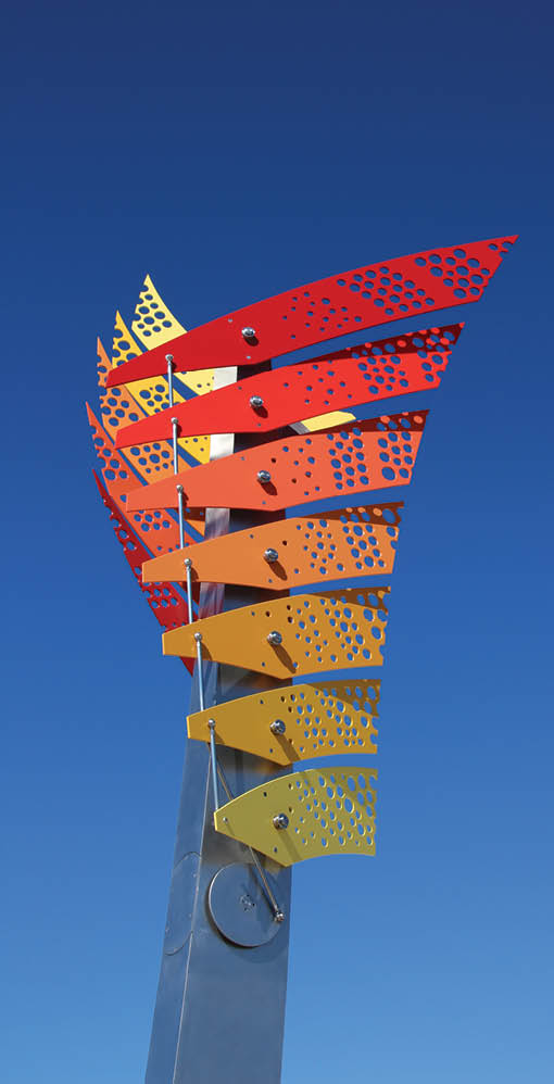 A colorful sculpture of a wind indicator is displayed in a blue sky. AI generated content