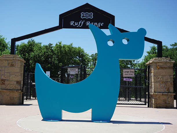 A blue sculpture of a dog is on display in a park. AI generated content
