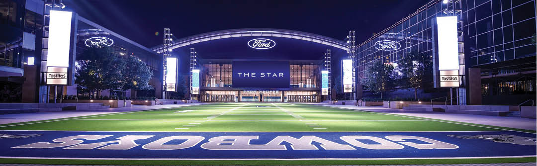A stadium with a large purple sign that says “Boomer Sooner" on the field. AI generated content