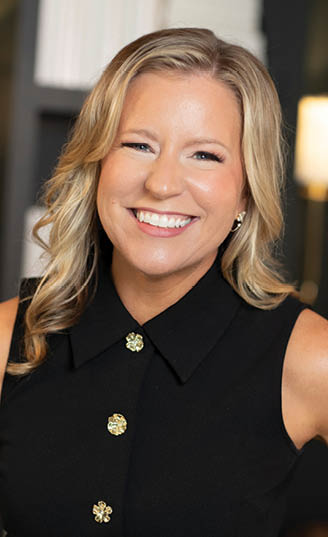 A woman wearing a black jacket and a gold button is smiling for the camera. AI generated content