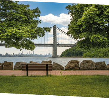 The George Washington Bridge, linking Northern Manhattan to Fort Lee, NJ, frames the New York City skyline. Opened in 1931, it's considered the busiest bridge in the world, averaging about 4 million vehicles per month.