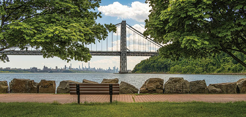 The George Washington Bridge, linking Northern Manhattan to Fort Lee, NJ, frames the New York City skyline. Opened in 1931, it's considered the busiest bridge in the world, averaging about 4 million vehicles per month.