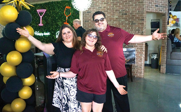 A man and woman pose for a picture in front of a bar. AI generated content