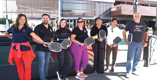 A group of people are standing on a tennis court, holding tennis rackets. AI generated content