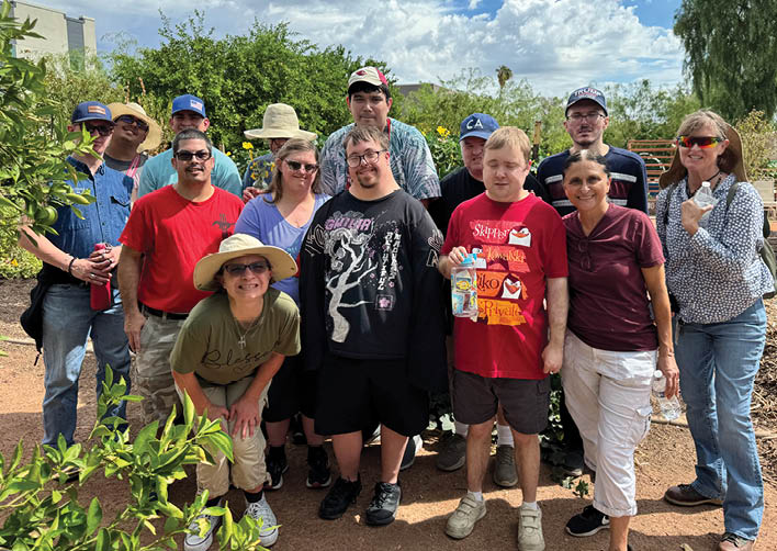 A group of people posing for a picture in a garden. AI generated content