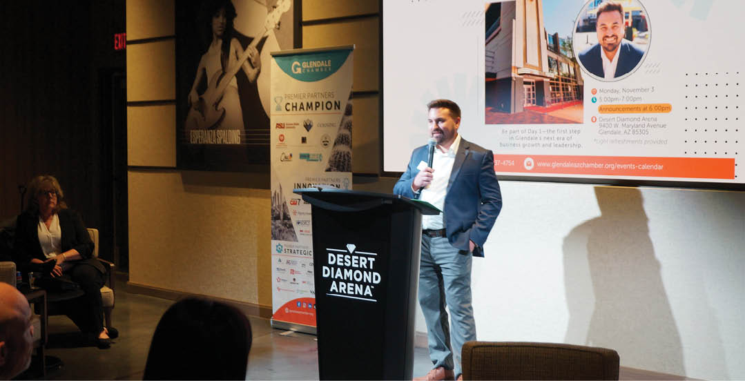 A man is standing in front of a large screen, giving a presentation. AI generated content