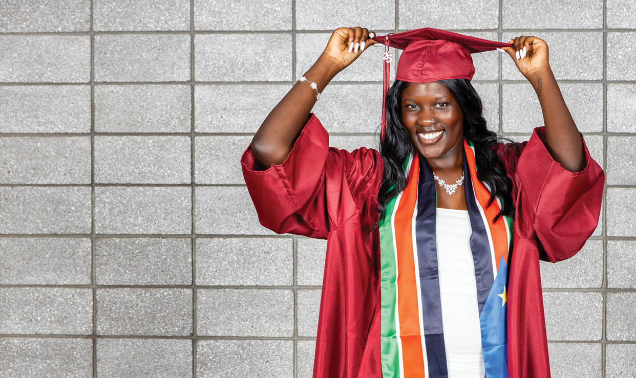 A woman wearing a red graduation gown with a black tassel on her head. AI generated content