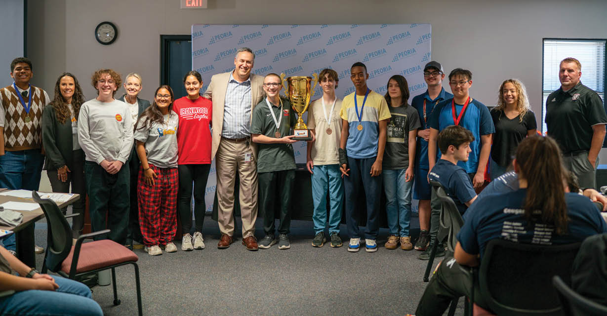 A group of people, including men and women, are standing in front of a podium. They are posing for a picture with a trophy. AI generated content