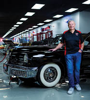 A man is standing in front of a black car. AI generated content