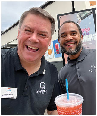 Two men are standing in front of a drink stand, smiling and enjoying their time. AI generated content