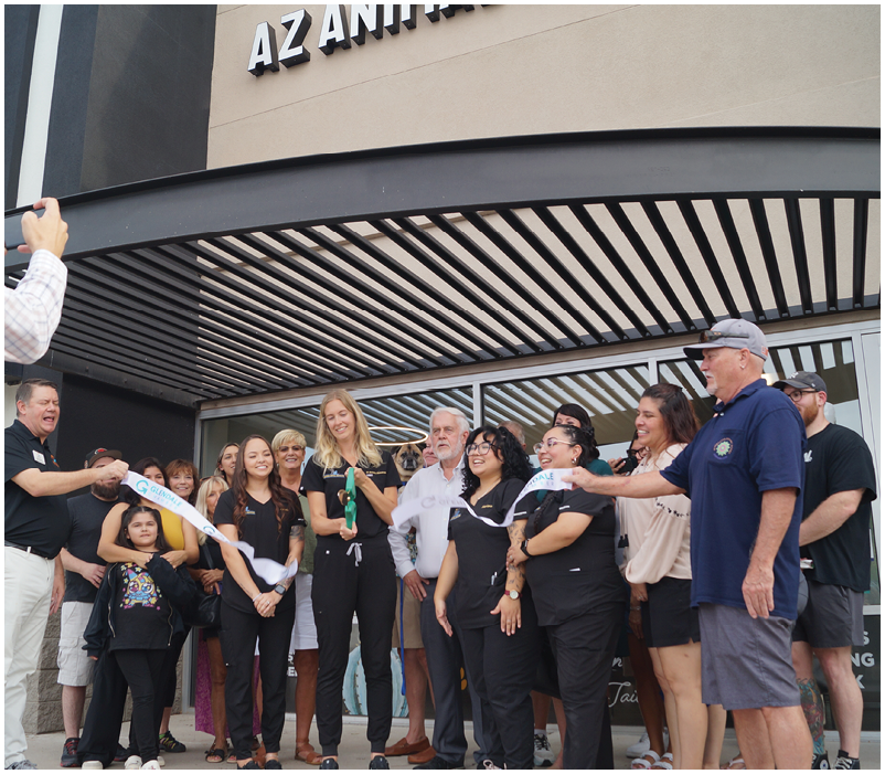 A group of people are standing outside a building, with one man taking a picture of the group with his cell phone. AI generated content
