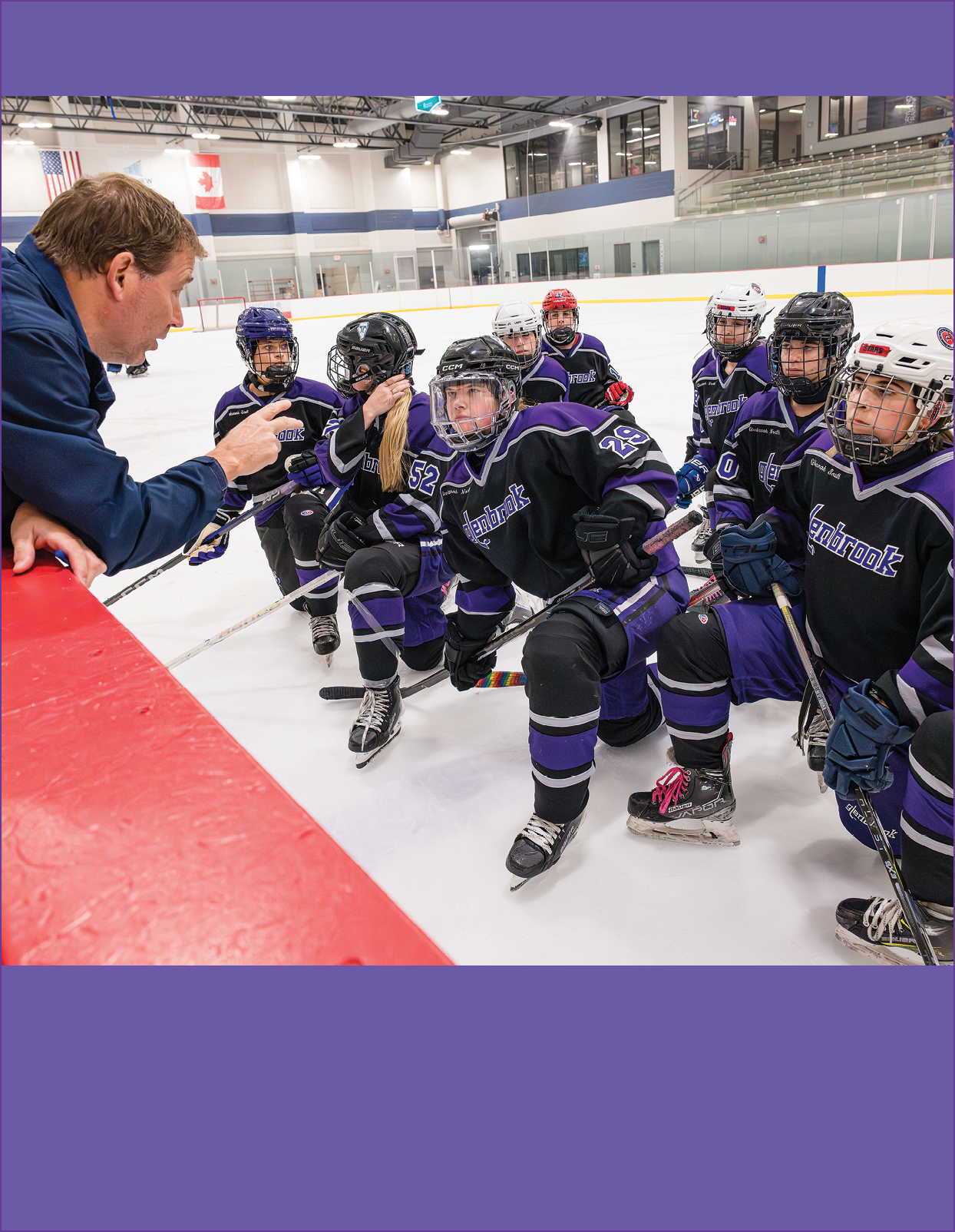 A group of people wearing purple and black uniforms. Description generated by AI