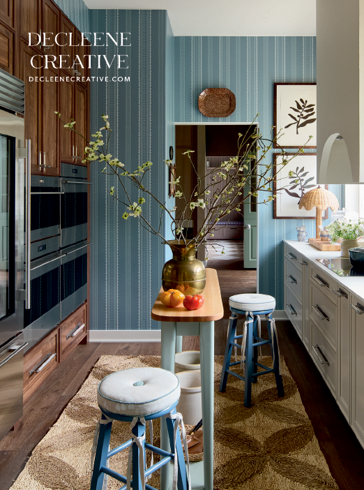 A kitchen with a blue table and stools. Description generated by AI