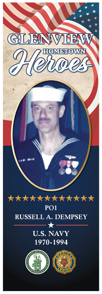 A man in a navy uniform is pictured on a poster. Description generated by AI