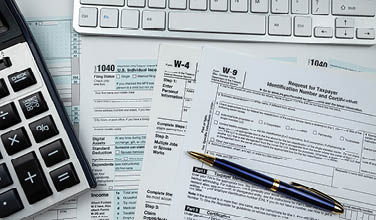 2022 blank 1040 us tax form with calculator and keyboard on office desk. Financial accounting concept